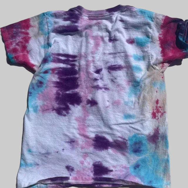 Tie-dye t-shirt with multicolor pattern on a plain background